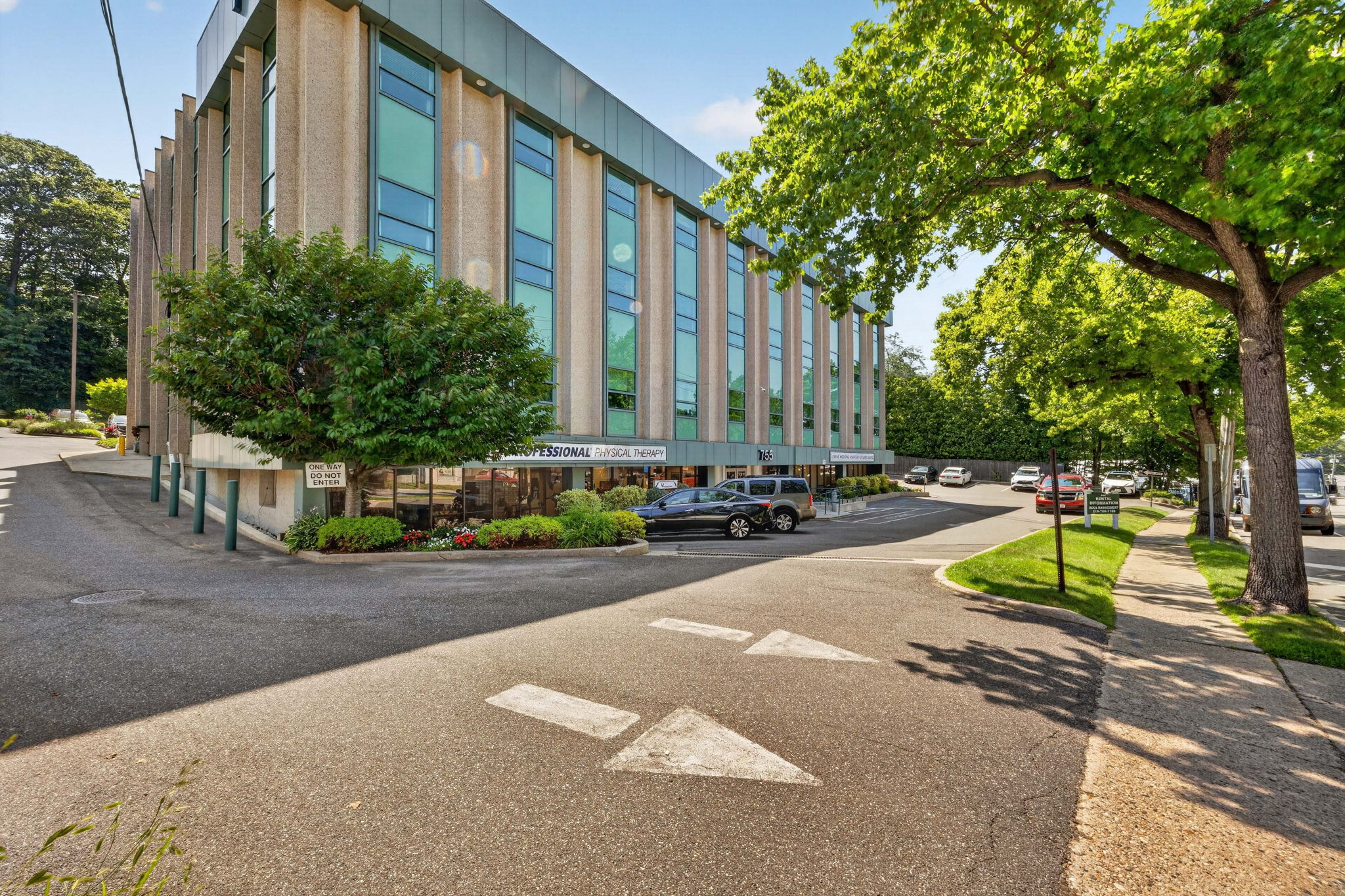 Tree-lined corner view of 755 New York Avenue
